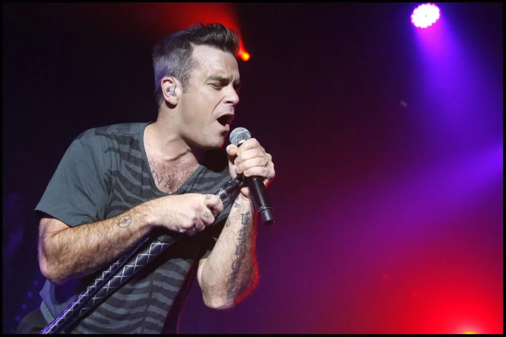 Robbie Williams performs on stage Robbie Williams