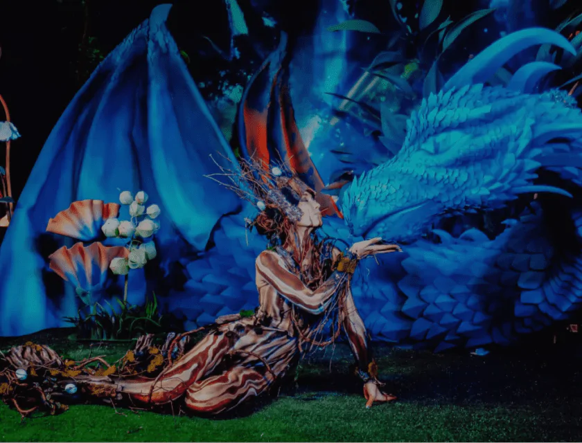 A girl dressed in a costume of a fantastic creature blows a kiss A girl dressed as a fantastic creature