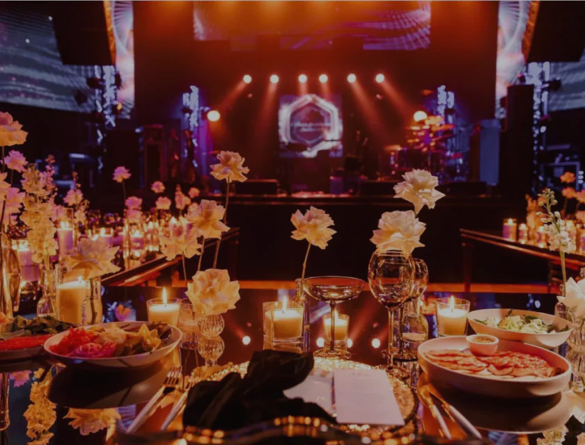 White flowers and candles in glasses stand on a beautifully decorated table White flowers are on the table