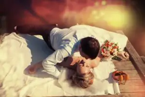 The bride and groom are photographed lying down The bride and groom are lying