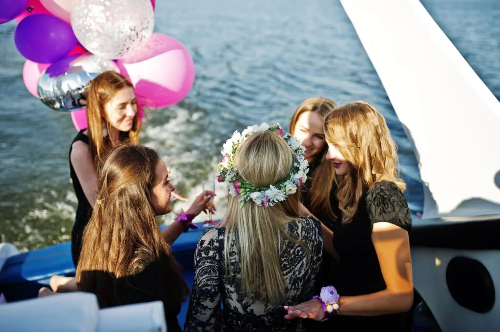 Girls with glasses of champagne and balloons celebrate on a yacht The girls celebrate on the yacht