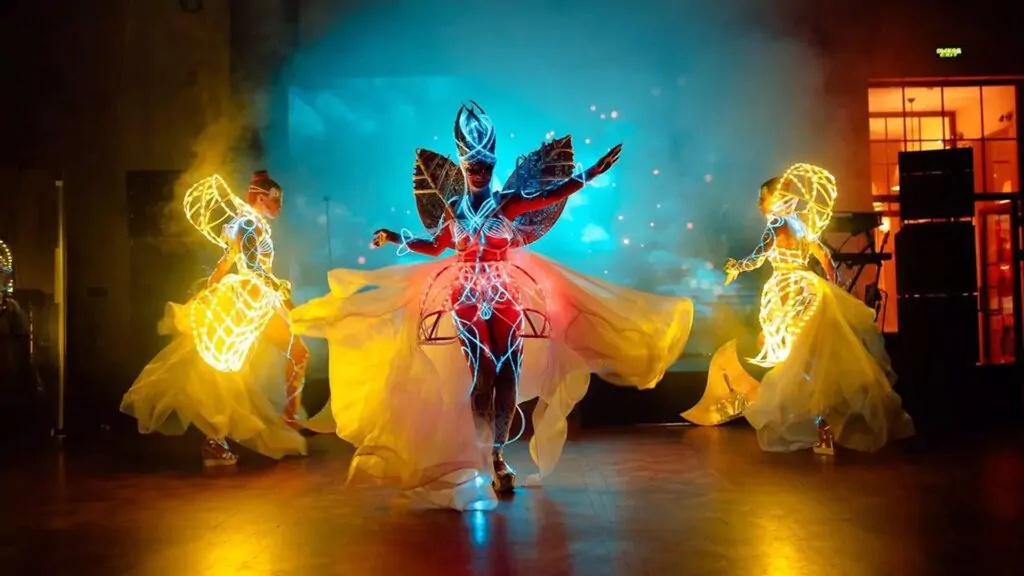 Dancers with glowing wings