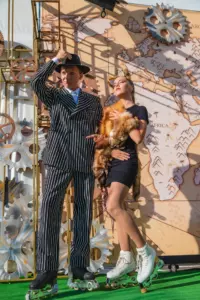 A man and a woman pose on roller skates