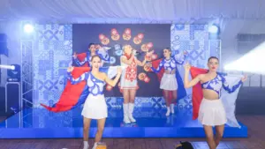 A girl sings in a white and red dress