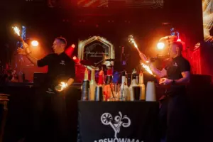 Bartenders toss bottles