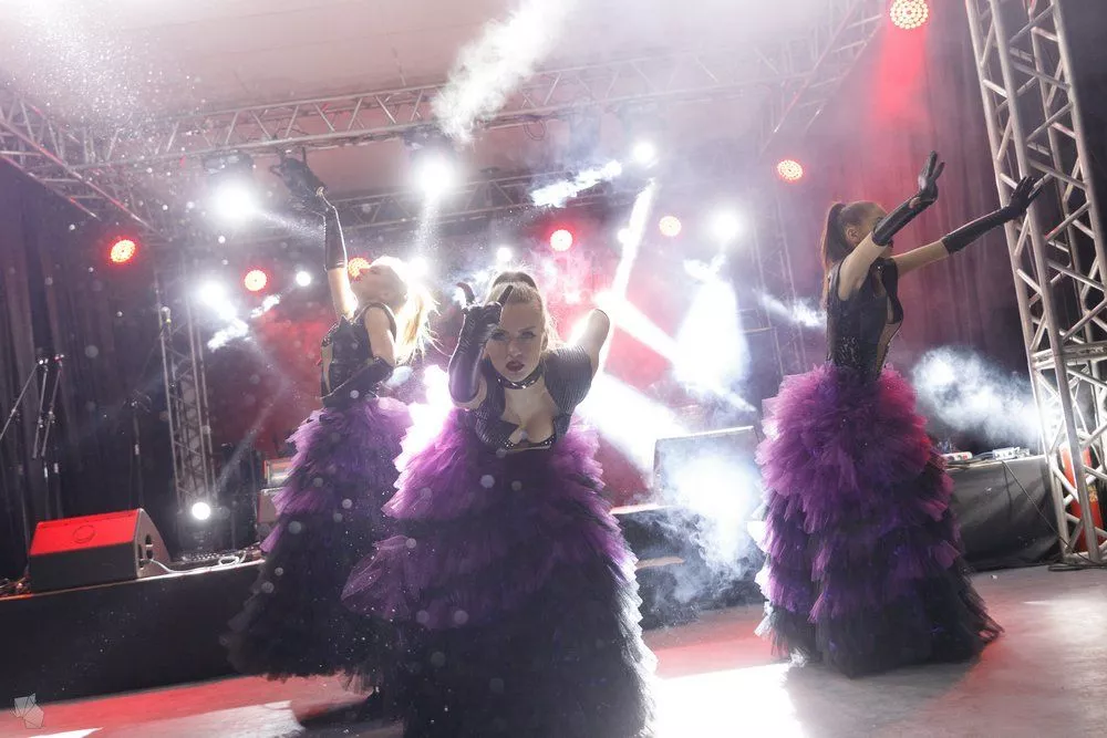 Three dancers in purple dresses