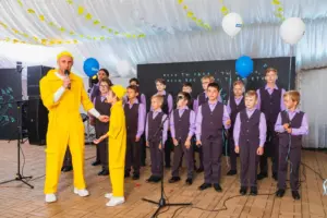 Children are standing on the stage