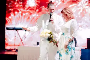 A man and a woman in white outfits