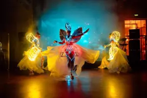 Three dancers in illuminated costumes