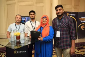 Four people are photographed at the conference