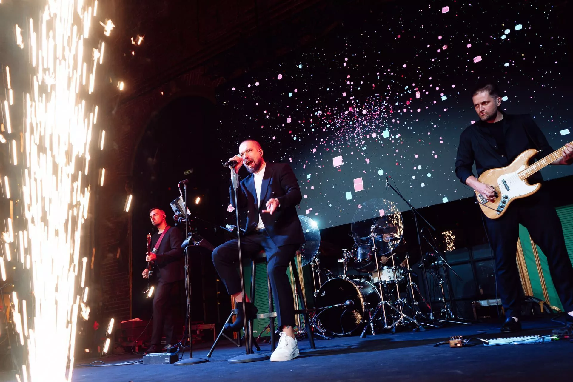 A musical group is performing on stage