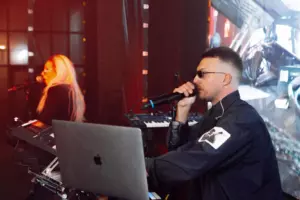 A musician performs on stage with a microphone