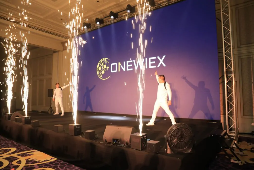 Event stage illuminated with fireworks and branded backdrop Stage with pyrotechnics and logo screen