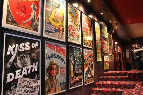 Wall decorated with vintage retro movie posters Wall with retro movie posters