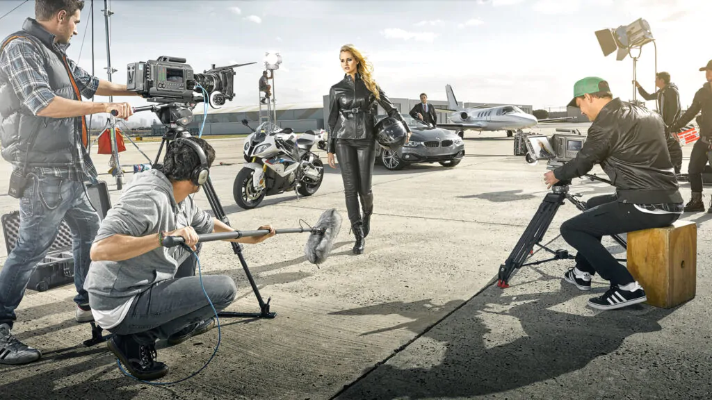 Stylish woman wearing leather near car and motorcycle Woman in leather outfit near car and motorcycle