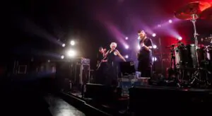 Musical band of three members performing live Three-person musical band performing
